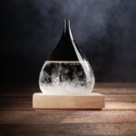 Vase en verre contenant un liquide clair avec des bulles, posé sur une base en bois, avec un fond sombre.