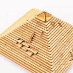 Pyramide en blocs de bois avec mesures précises et angles, illustrant des concepts géométriques et mathématiques pour l'éducation ou la décoration scientifique.