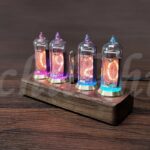Vitrine avec quatre tubes à vide illuminés, affichant des couleurs vibrantes et un design rétro, parfaits pour la décoration scientifique ou vintage.