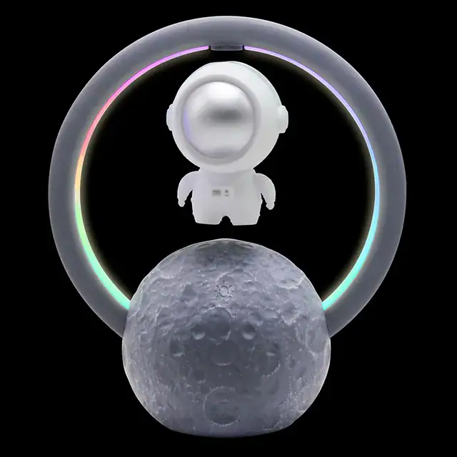 Figurine de cosmonaute avec anneau lumineux coloré et lune en décoration, idéale pour un univers scientifique ou spatial.