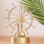 Objet scientifique | Horloge design en forme de roue solaire dorée.