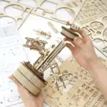 Poupée de bois mécanique en cours d'assemblage, avec plusieurs pièces en bois et outils de montage.