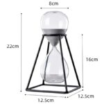 Sablier de décoration en verre avec cadre en métal noir, mesure 22 cm de haut, 8 cm de diamètre, parfait pour une décoration scientifique ou moderne.