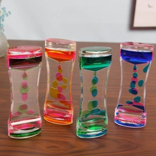 Vase en verre transparent avec bulles colorées roses, oranges, vertes et bleues, idéal pour la décoration scientifique ou moderne.