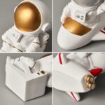 Figurine de vaisseau spatial avec détails dorés et rouges, idéale pour la décoration scientifique ou thématique.