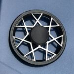 Poulie de moteur pour machine à café, pièce détachée en plastique noir avec un design en étoile blanche, utilisée pour la transmission de mouvement dans les appareils électroménagers.