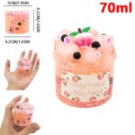 Petit pot de gelĂ©e de pĂȘche rose avec dĂ©corations de fruits et yeux, contenant 70ml, idĂ©al pour la dĂ©coration ou la collection scientifique.