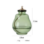 Balayette à épices en verre vert avec bouchon en métal et tuyau intégré, idéal pour la décoration de cuisine ou comme objet scientifique vintage.