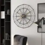 Horloge murale géométrique en métal noir avec aiguilles dorées, décoration contemporaine pour intérieur élégant.