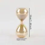 Porte-sablier en verre transparent avec sable beige, mesurant 19 cm de haut et 8 cm de large, idéal pour la décoration scientifique ou comme objet de bureau original.