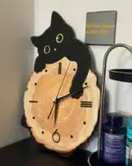 Horloge murale en forme de chat noir avec cadran en bois naturel, décoration originale pour les amateurs d'animaux et de design moderne.