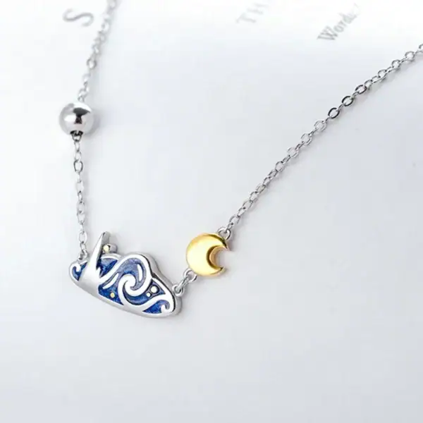 Collier délicat avec pendentif lune en or et constellation en argent, parfait pour les amateurs d'astronomie et de sciences.