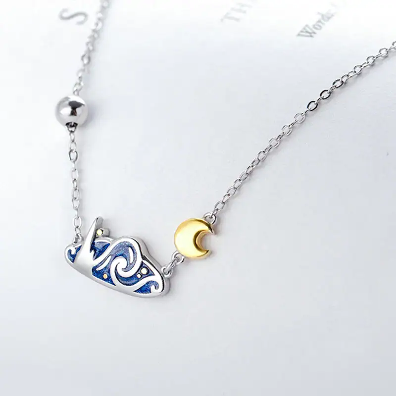 Collier délicat avec pendentif lune en or et constellation en argent, parfait pour les amateurs d'astronomie et de sciences.