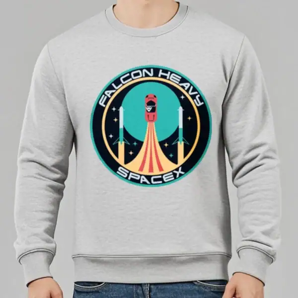 Sweatshirt gris avec logo Falcon Heavy SpaceX, illustration d'une fusée en lancement dans un style graphique moderne, idéal pour les amateurs d'espace et de technologie.