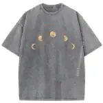 T-shirt gris avec motif de phases de la lune en doré, représentant différentes étapes lunaires dans un design minimaliste et élégant.