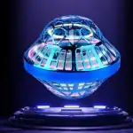 Modèle de vaisseau spatial en verre avec éclairage LED multicolore, exposé sur un socle noir, illustrant un objet scientifique décoratif et futuriste.
