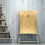 Illustration de l'Homme de Vitruve de Léonard de Vinci, montrant un homme aux proportions parfaites avec bras et jambes étendus, sur un fond en bois clair.