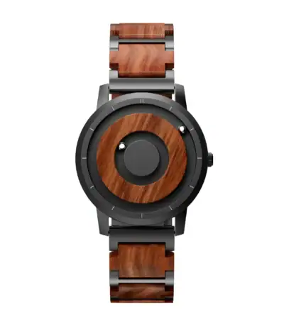 Montre en bois et métal avec design moderne et sophistiqué, alliant matériaux naturels et finition élégante. Parfaite pour un style unique et écologique.