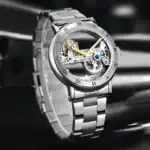 Montre squelette mécanique en acier inoxydable avec mouvement visible, design élégant et sophistiqué, idéale pour les amateurs de science et de décoration horlogère.