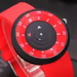 Une image d'un chronomètre ou d'un minuteur de couleur rouge avec des détails noirs, utilisé pour mesurer le temps.