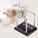 Pendule Newton pour enfants, jouet scientifique éducatif et objet de décoration moderne. Parfait pour stimuler la curiosité et l'apprentissage des principes physiques chez les jeunes.