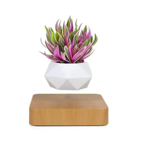 Plante artificielle en pot blanc avec feuilles vertes et roses, décoration moderne et scientifique.