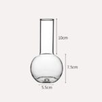 Bocal en verre de laboratoire avec une capacité de 7,5 cm de hauteur et 5,5 cm de diamètre, idéal pour expériences scientifiques ou décoration.