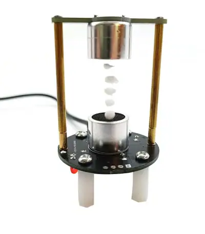 Dispositif scientifique miniature illustrant une expérience avec billes et cylindre en verre, parfait pour la décoration ou l'éducation scientifique.