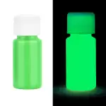 Bouteille de peinture phosphorescente verte visible en lumière normale et brillante dans l'obscurité, idéale pour décoration ou projets artistiques lumineux.