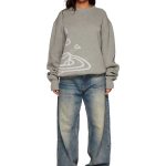 Pull en maille gris clair décontracté porté par une femme, style casual avec jeans.