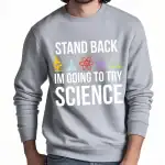 Sweatshirt gris avec message humoristique sur la science, "Stand back, I'm going to try science", avec icônes de laboratoire colorées.