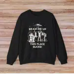 T-shirt noir avec illustration humoristique et texte "Beam me up, this place sucks!" pour les amateurs de science et d'humour.