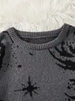 Gros plan sur un pull en laine gris foncé avec motif d'étoile noir, posé sur un fond en peluche blanche, idéal pour la décoration scientifique et la mode.